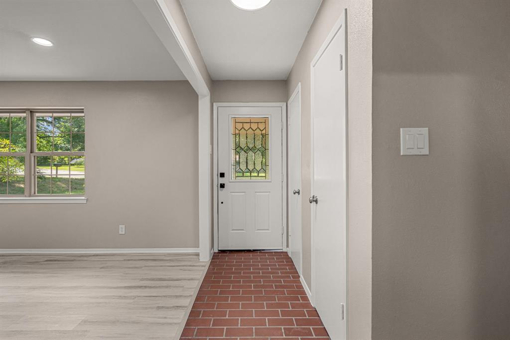 2216 Archer Trail Denton, TX 76209 - Photo 4 of 26 a view of a hallway with wooden floor and a window