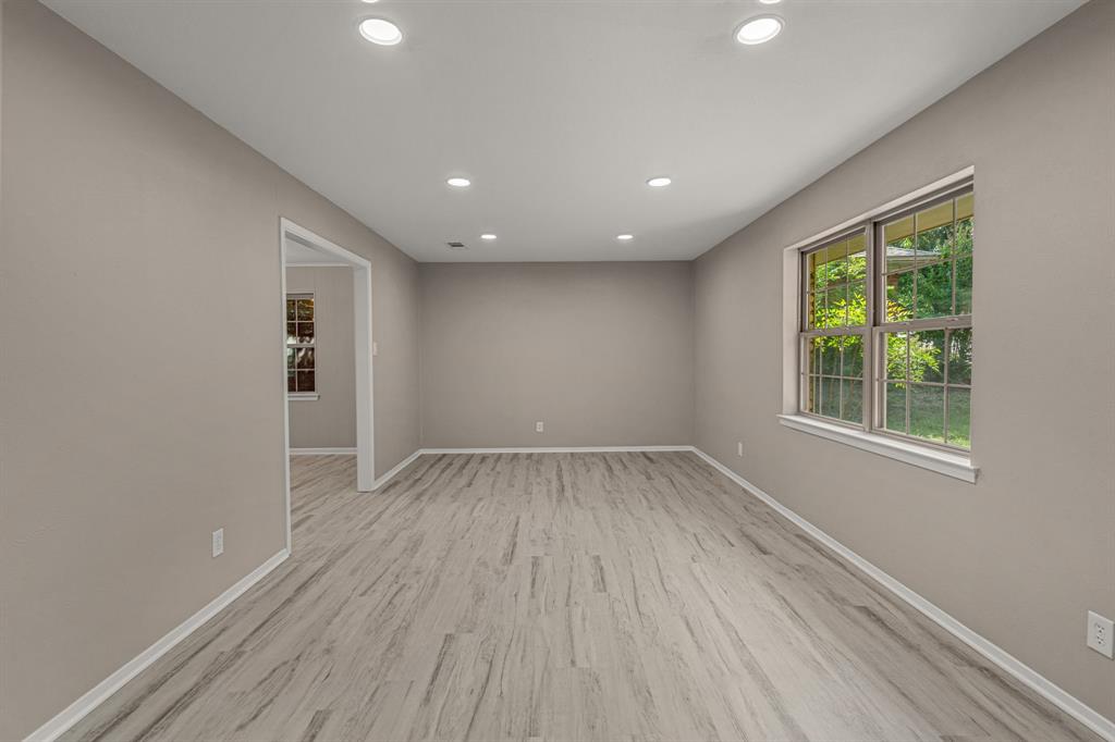 2216 Archer Trail Denton, TX 76209 - Photo 6 of 26 an empty room with wooden floor and windows