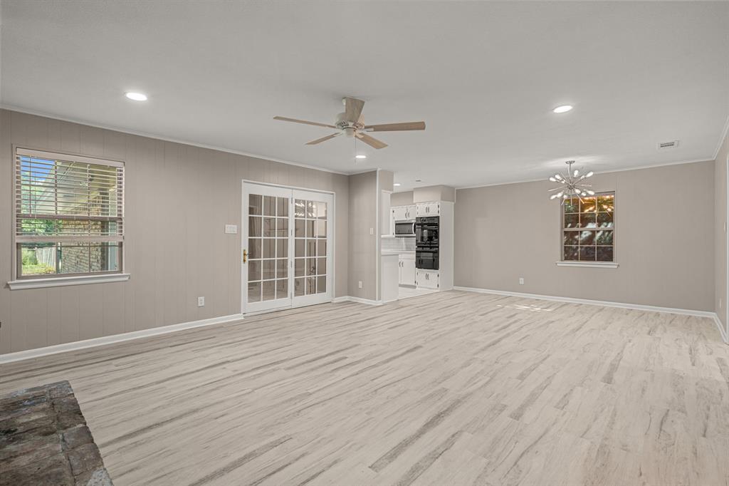 2216 Archer Trail Denton, TX 76209 - Photo 10 of 26 a view of an empty room with a window and a kitchen