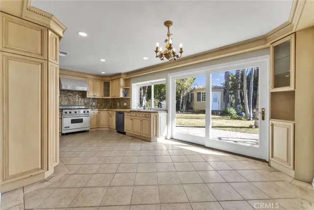 a large kitchen with granite countertop a sink and a stove