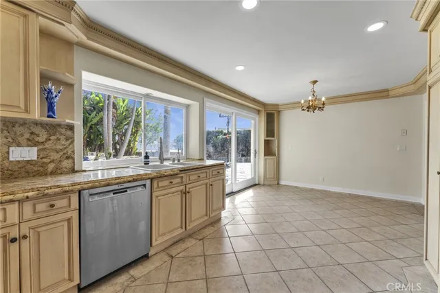 a view of a kitchen with a sink and refrigerator