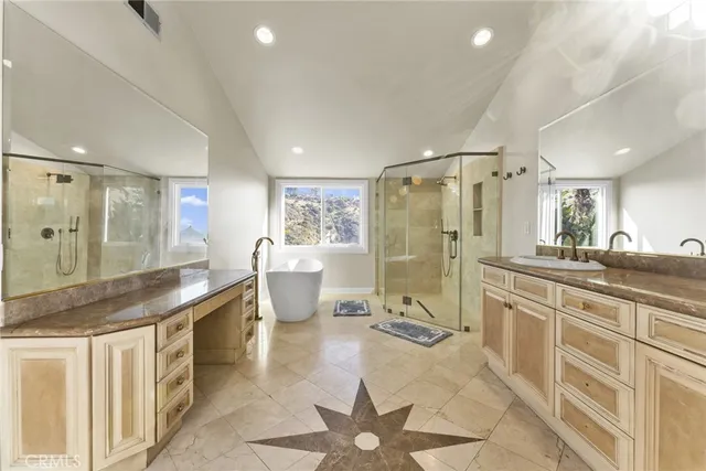 a bathroom with a sink a toilet a shower and mirror