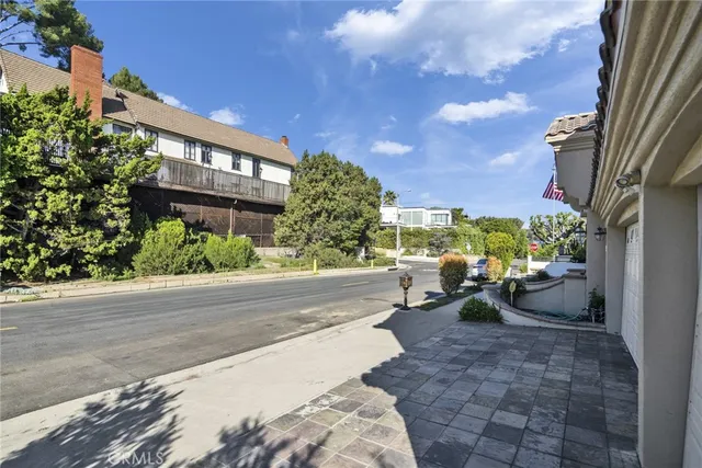 a view of a patio with couches and table and chairs and potted plants