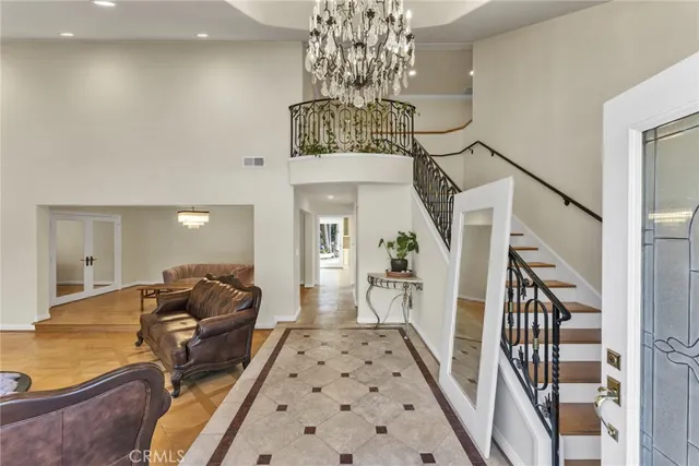 a living room with furniture and a chandelier