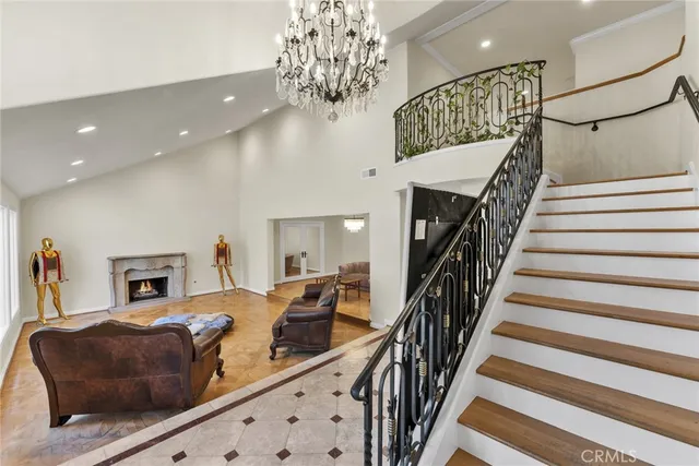 a living room with furniture fireplace and a large window