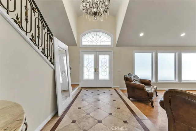 a living room with furniture a fireplace and a chandelier