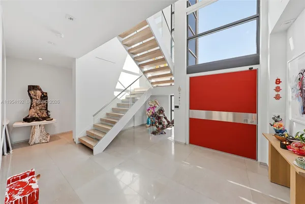 a living room with furniture tv and a large window
