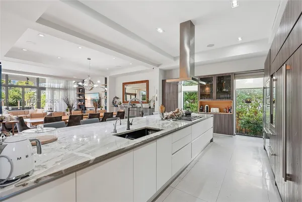 a living room with furniture and floor to ceiling windows