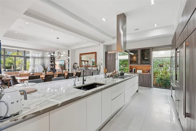 a living room with furniture and floor to ceiling windows
