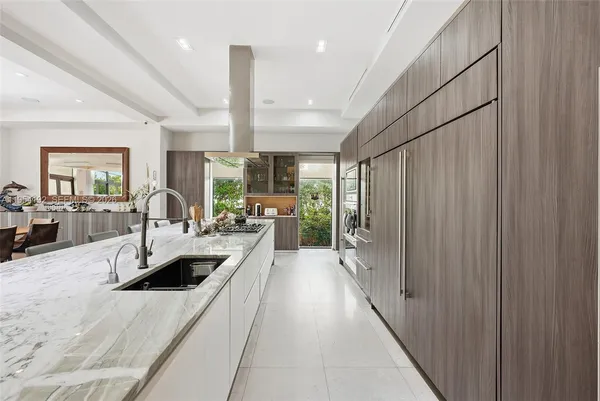 a living room with furniture and large windows