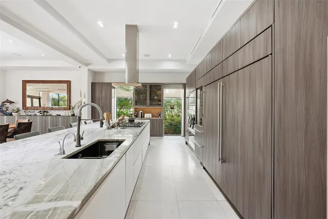 a living room with furniture and large windows