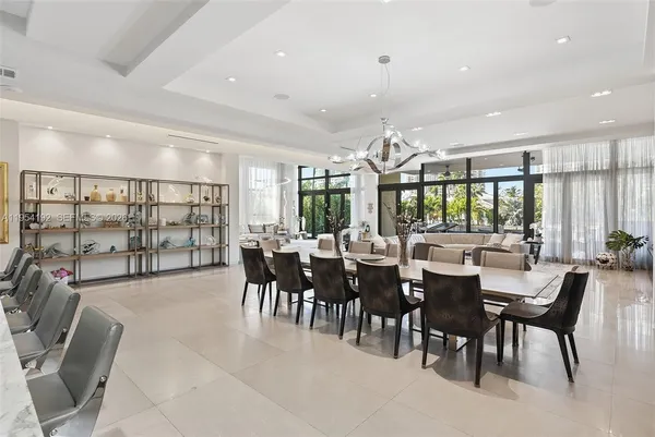 a living room with furniture and large windows