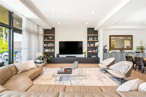a large white kitchen with a large window and sink