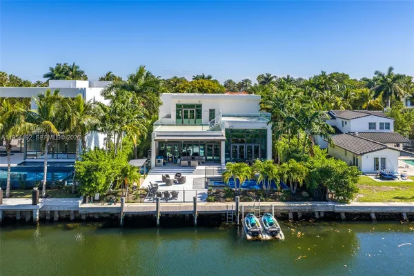 a large kitchen with kitchen island granite countertop a large counter top a sink stainless steel appliances and cabinets