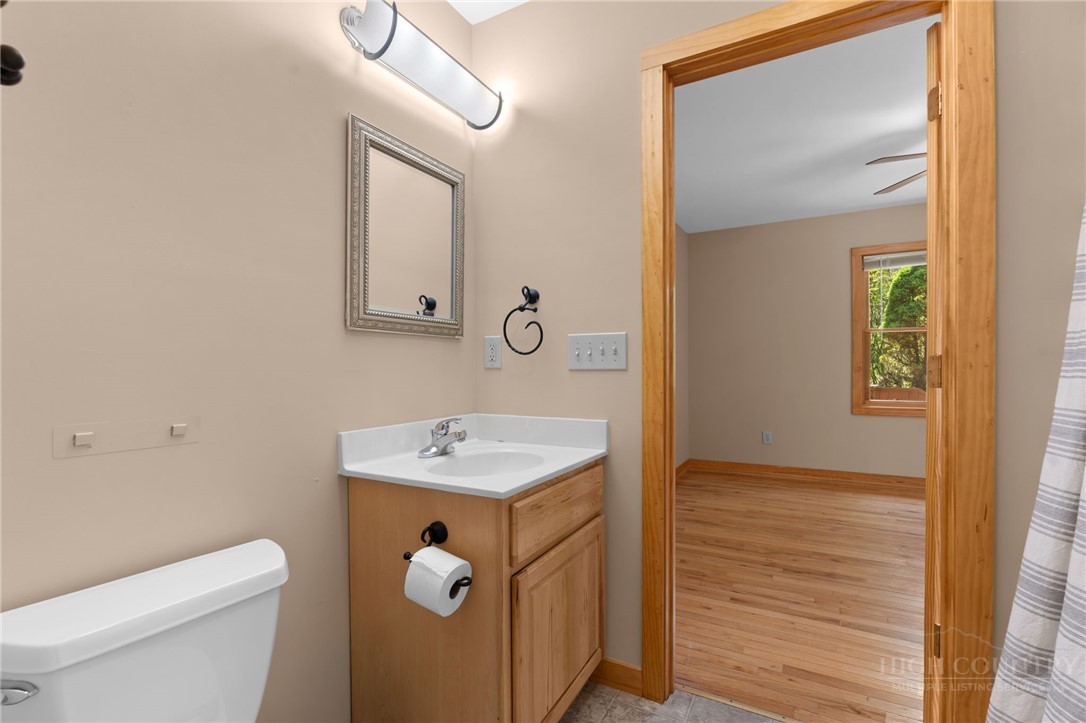 148 Woodby Ridge Road Vilas, NC 28692 - Photo 26 of 33 a bathroom with a sink a toilet and a mirror