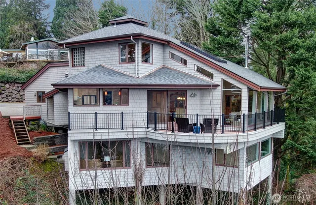 a aerial view of a house with a deck and furniture