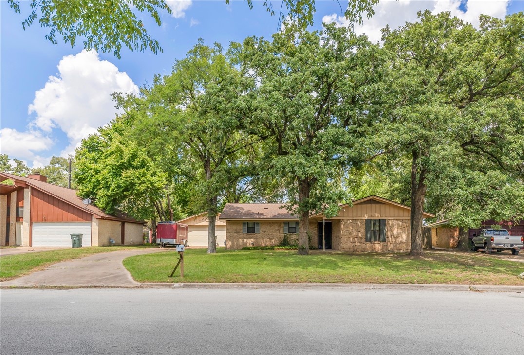 3207 Forestwood Drive Bryan, TX 77801 - Photo 1 of 1 a yellow house with trees in front of it
