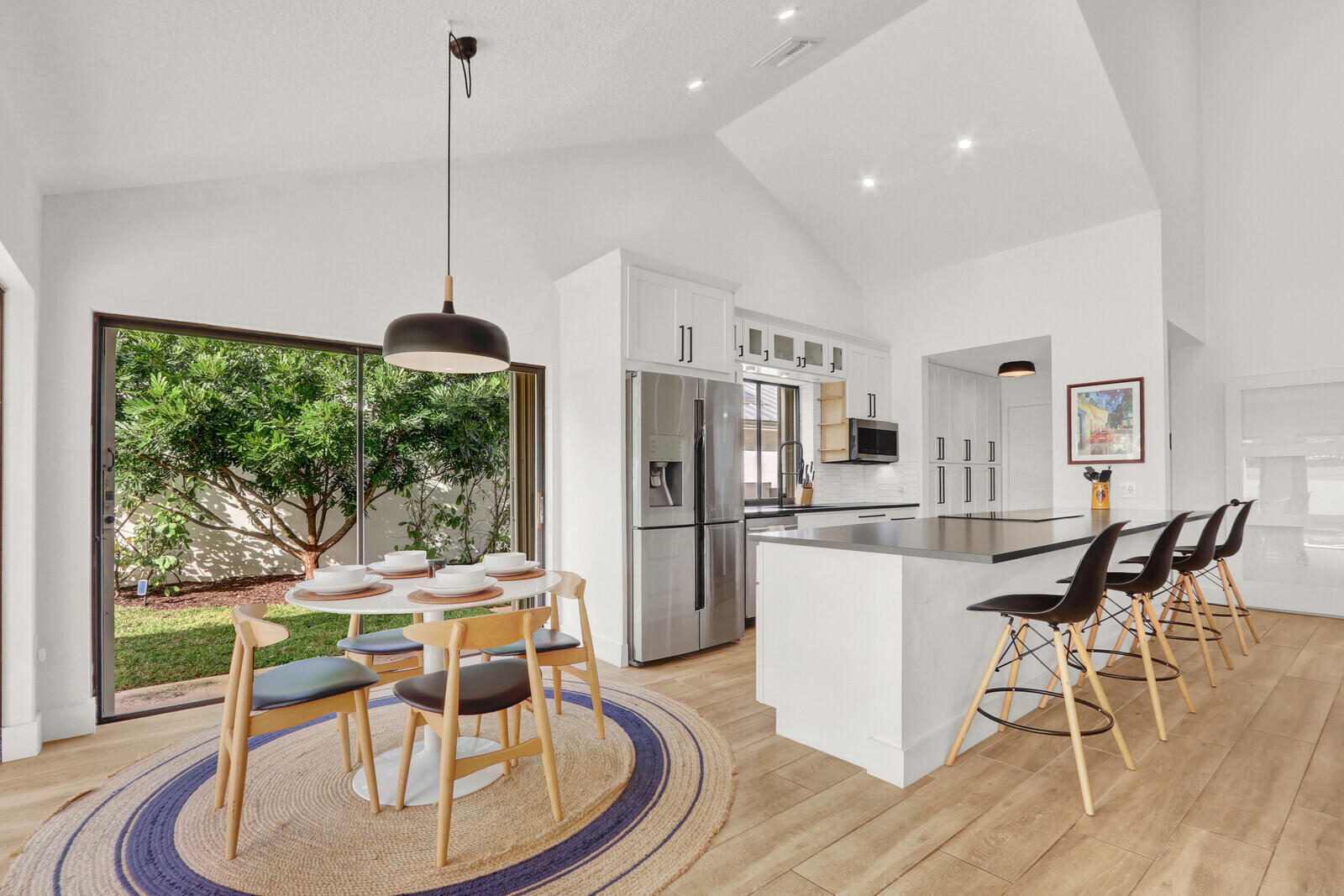 a dining room with furniture a chandelier and wooden floor
