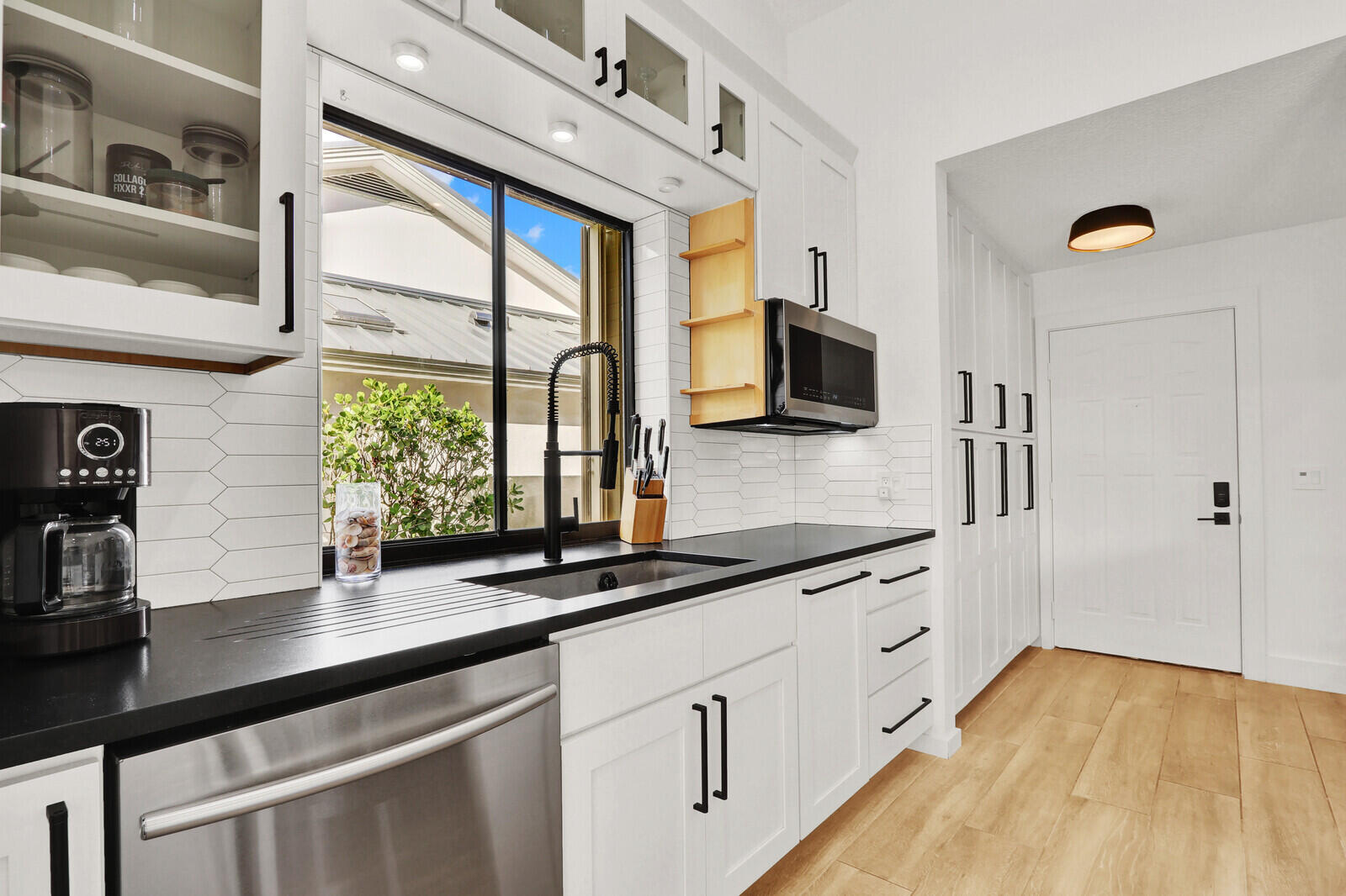 246 Ridge Road Jupiter, FL 33477 - Photo 5 of 39 a kitchen with stainless steel appliances granite countertop a sink and a wooden floors