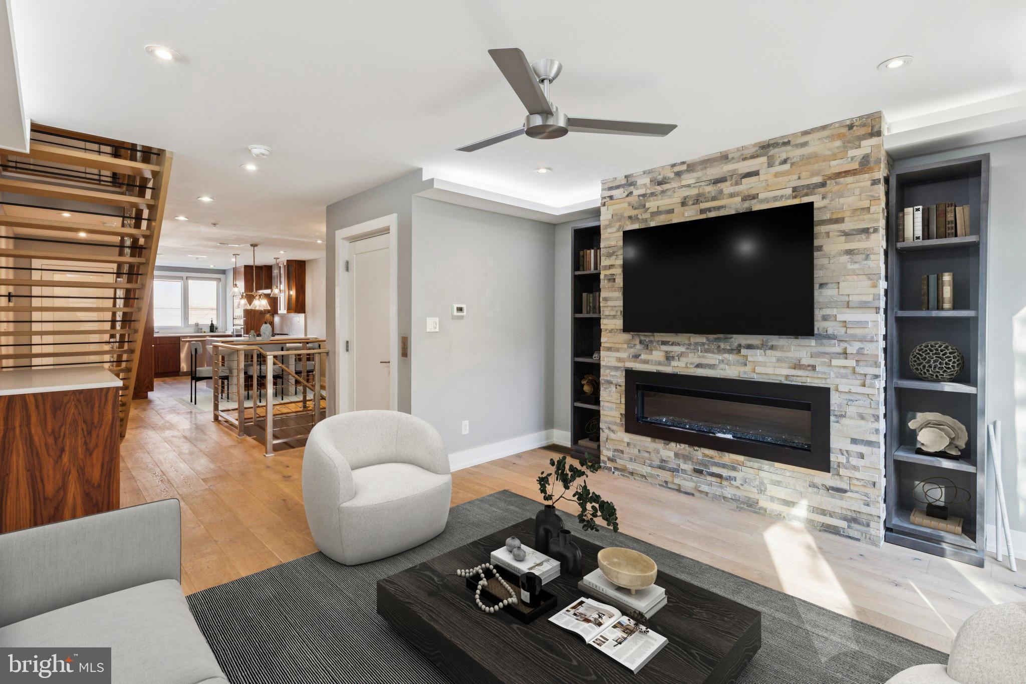 719 South 20th Street Philadelphia, PA 19146 - Photo 17 of 53 a living room with furniture a flat screen tv and a fireplace