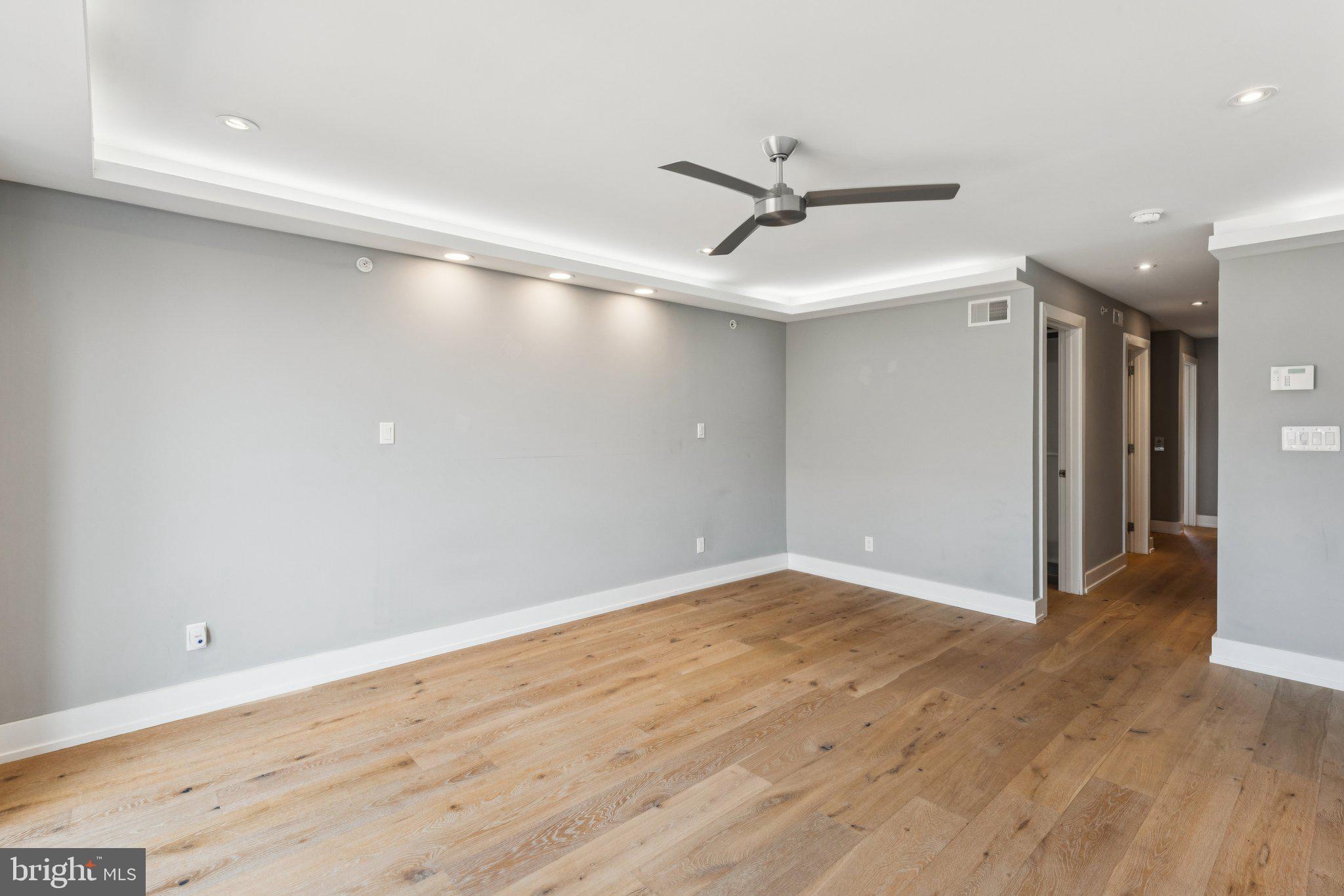 719 South 20th Street Philadelphia, PA 19146 - Photo 32 of 53 a view of a big room with wooden floor a ceiling fan and kitchen space