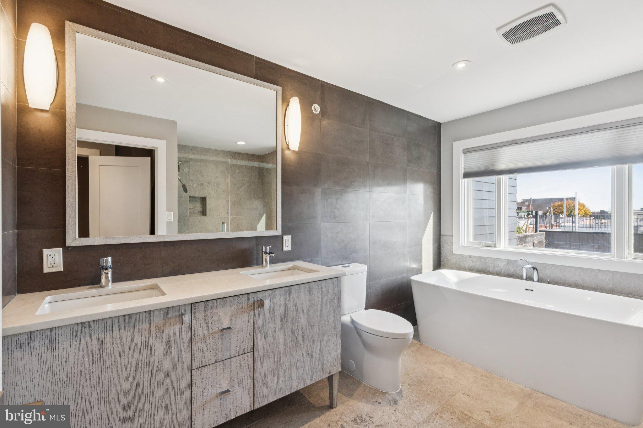 719 South 20th Street Philadelphia, PA 19146 - Photo 36 of 53 a bathroom with a double vanity sink mirror double and bathtub