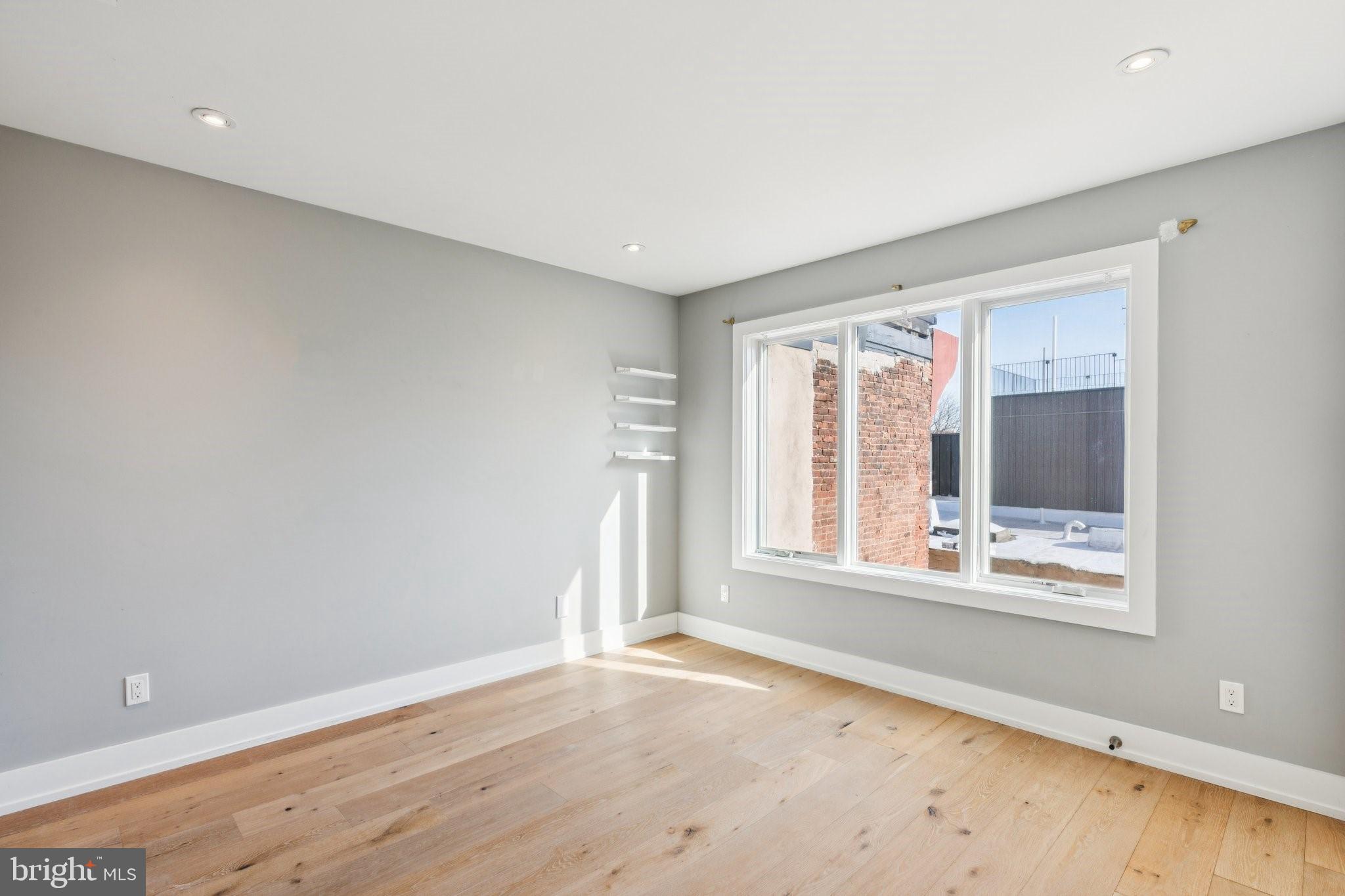 719 South 20th Street Philadelphia, PA 19146 - Photo 44 of 53 a view of an empty room with wooden floor and a window