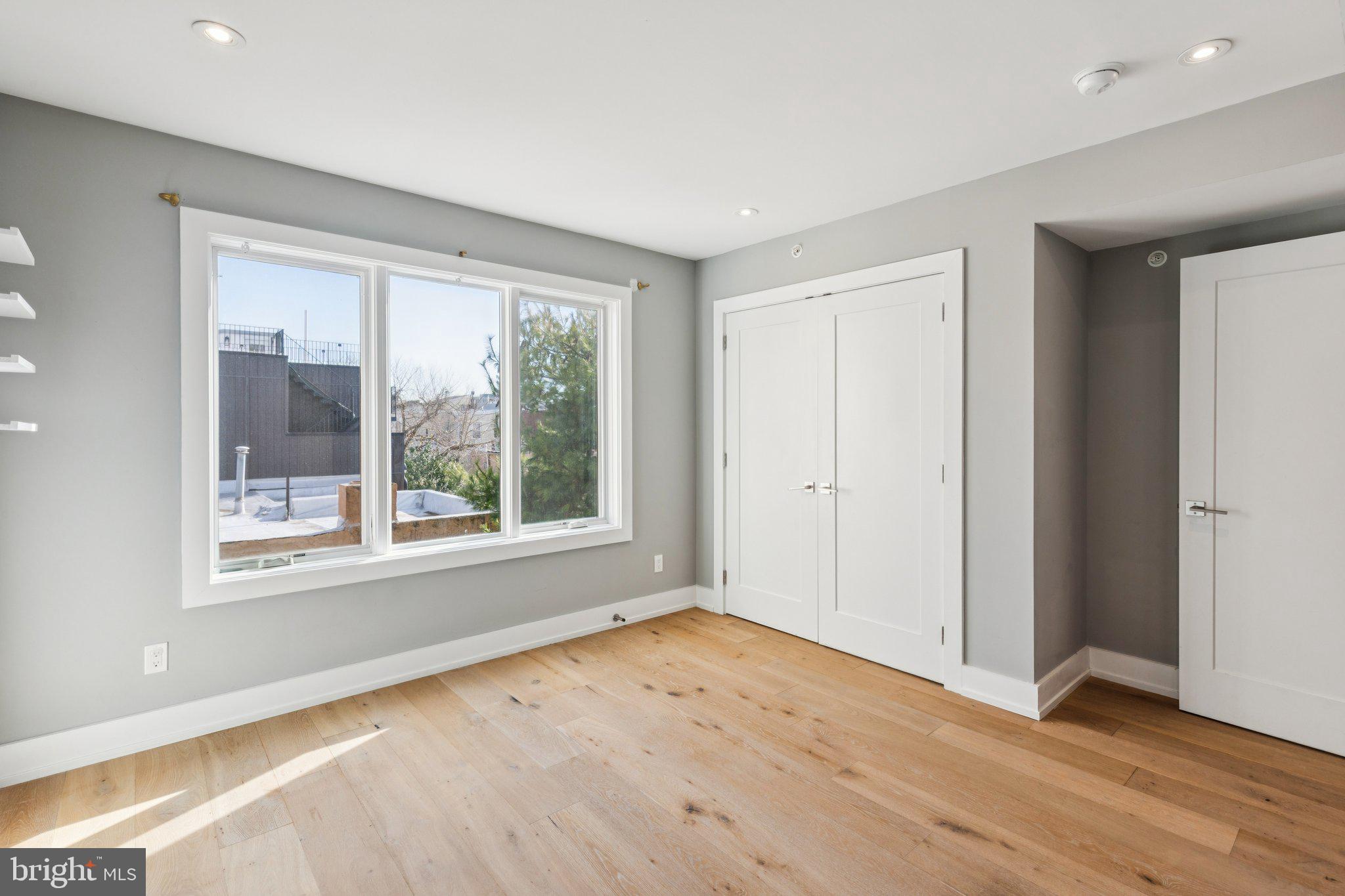 719 South 20th Street Philadelphia, PA 19146 - Photo 45 of 53 a view of an empty room with wooden floor and a window