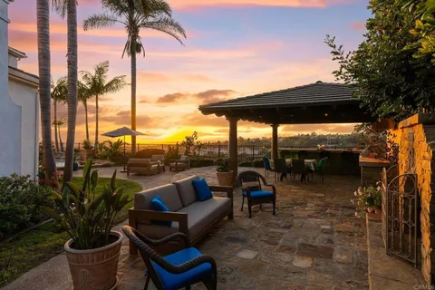 a roof deck with table and chairs potted plants with swimming pool and outdoor seating