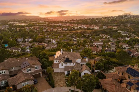an aerial view of residential houses with city view