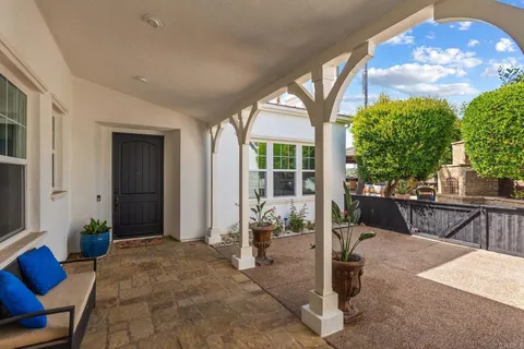 a view of living room filled with furniture and a potted plant