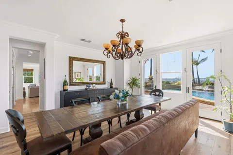 a living room with furniture dining table and a large window