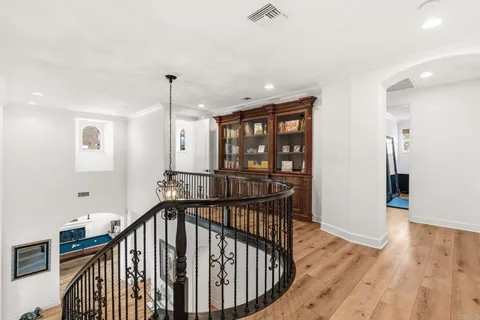 a view of a room that has a bed and glass door