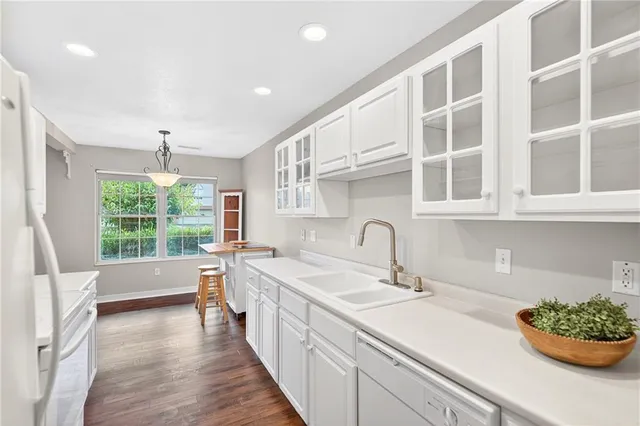 a kitchen with stainless steel appliances granite countertop a sink and cabinets