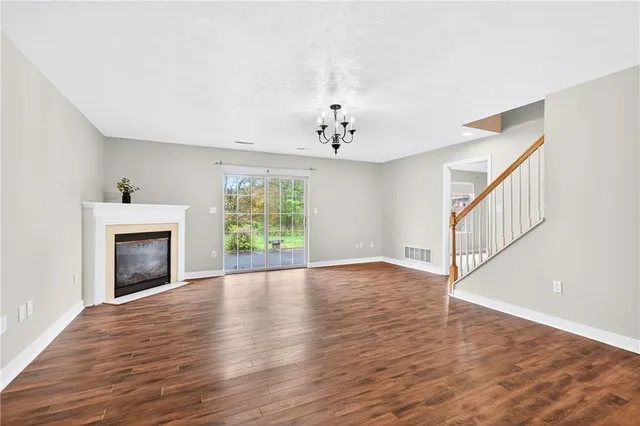 wooden floor in an empty room with a fireplace