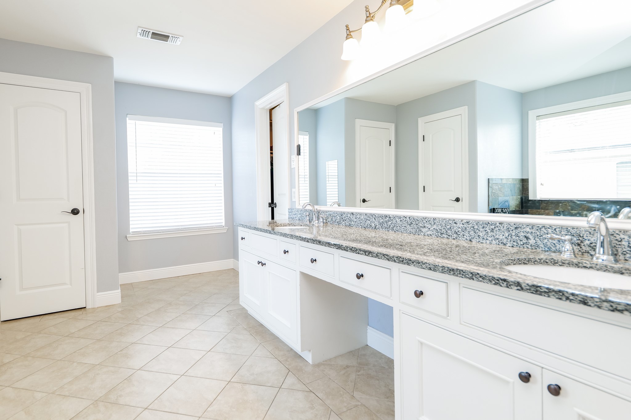 11606 Curry Ridge Lane Tomball, TX 77377 - Photo 15 of 28 The large master bathroom features double sinks, a spacious separate shower, and a luxurious soaking tub, providing both comfort and functionality.