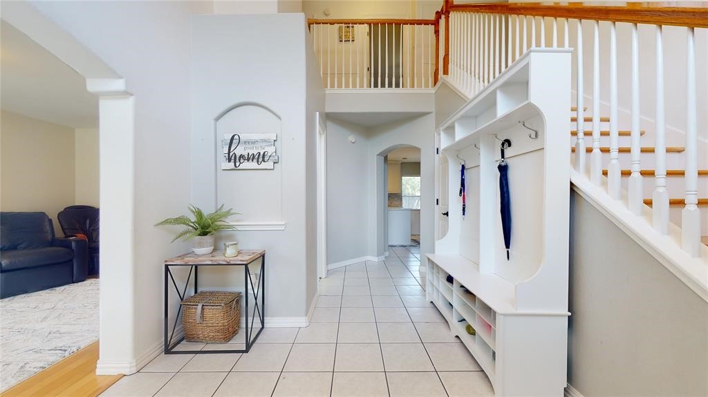 11606 Curry Ridge Lane Tomball, TX 77377 - Photo 2 of 28 The entrance to the home features a grand two-story foyer with an elegant arched window and abundant natural light.