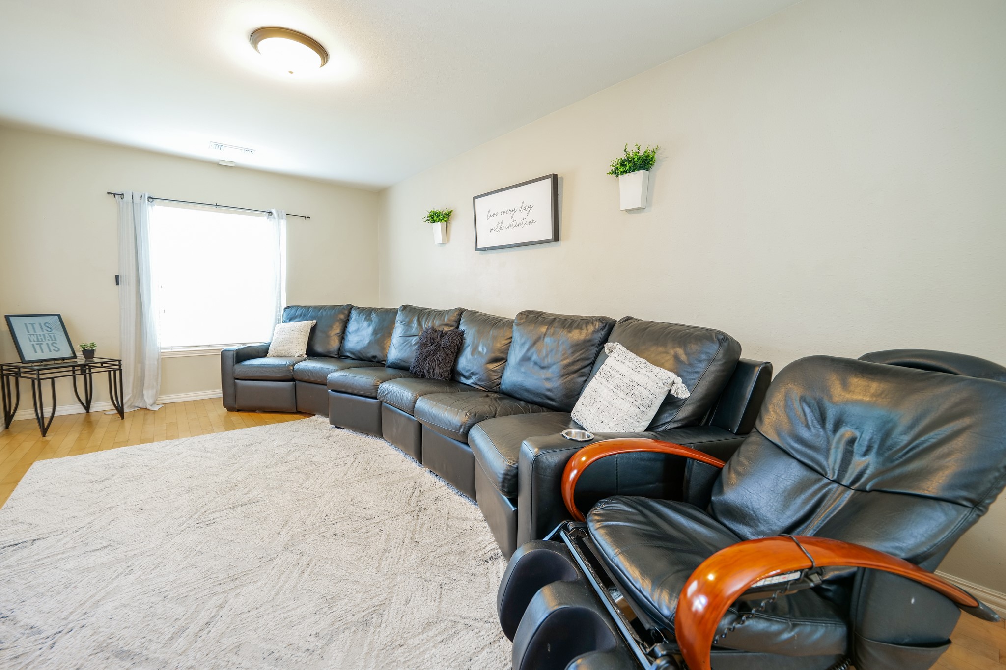 11606 Curry Ridge Lane Tomball, TX 77377 - Photo 3 of 28 The spacious living room boasts abundant natural light, warm hardwood floors, and enough space for an oversized couch, perfect for relaxing or entertaining guests.
