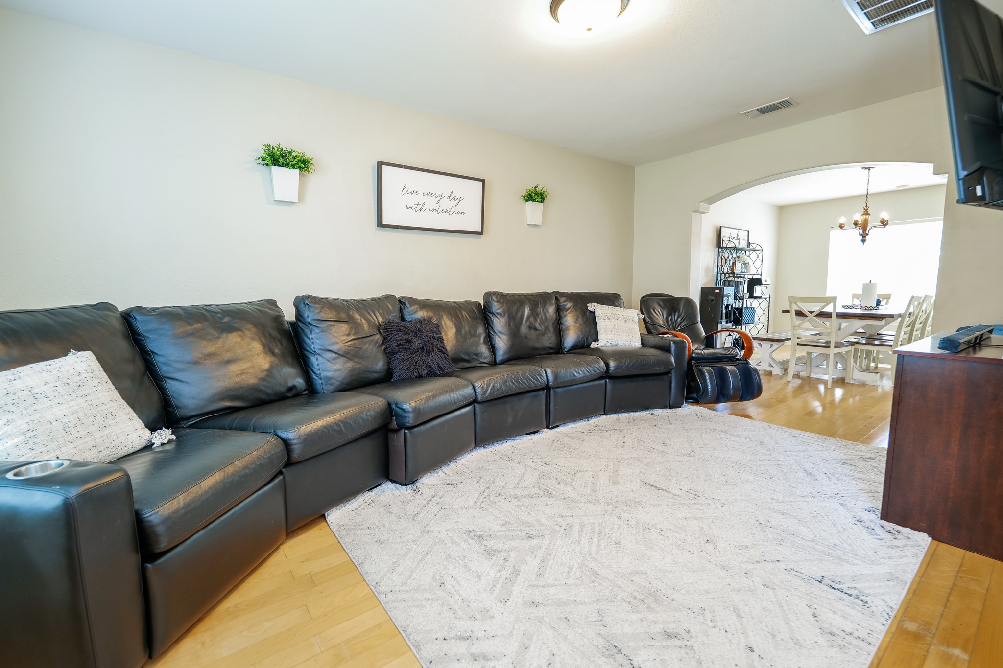 11606 Curry Ridge Lane Tomball, TX 77377 - Photo 4 of 28 The bright and open living room seamlessly flows into the dining area, creating an inviting space ideal for both everyday living and entertaining.
