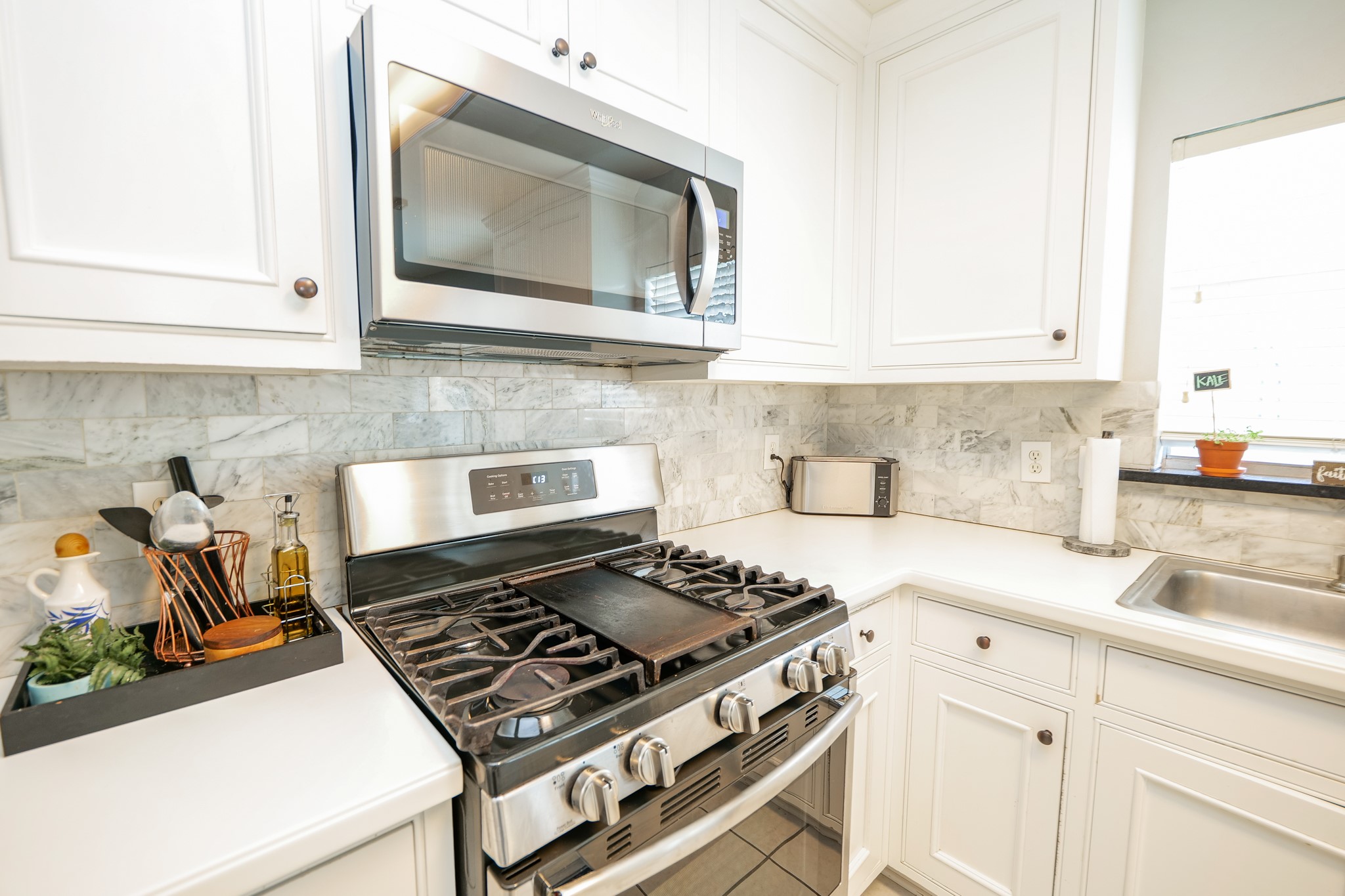 11606 Curry Ridge Lane Tomball, TX 77377 - Photo 9 of 28 The home features a sleek, stainless steel stove that combines modern style with everyday functionality.