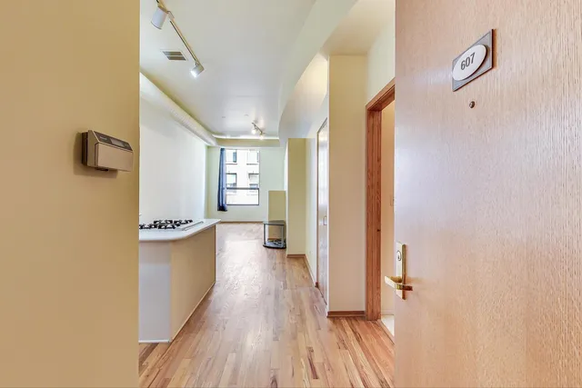 a view of a hallway view with wooden floor and staircase