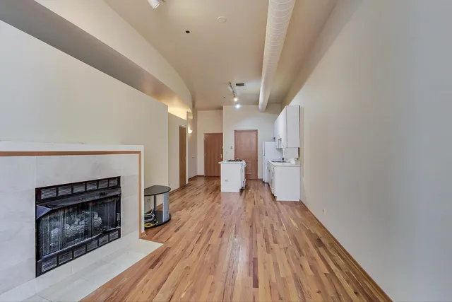 a view of a room wooden floor and a kitchen