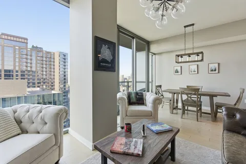 a living room with furniture and a large window