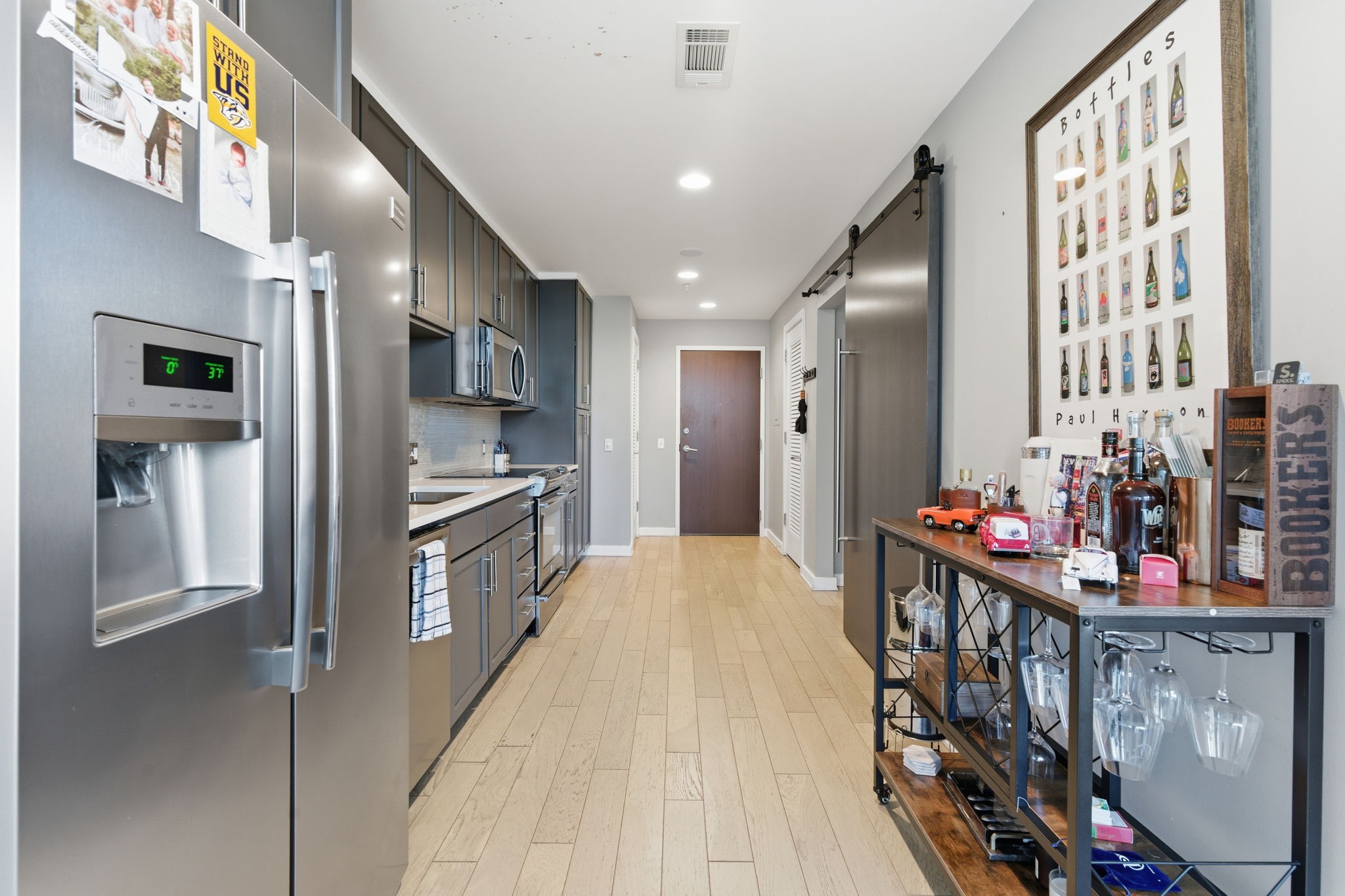 1212 Laurel Street, Unit 2010 Nashville, TN 37203 - Photo 5 of 11 a kitchen view with stainless steel appliances kitchen island granite countertop a refrigerator and a stove