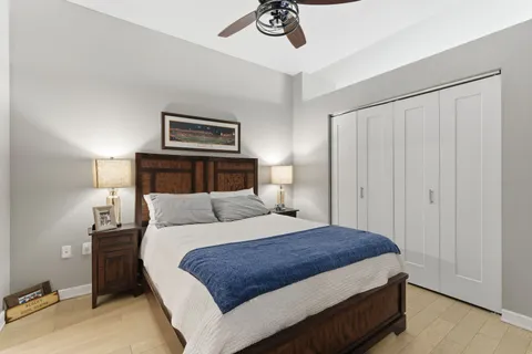 a bedroom with a bed and a chandelier