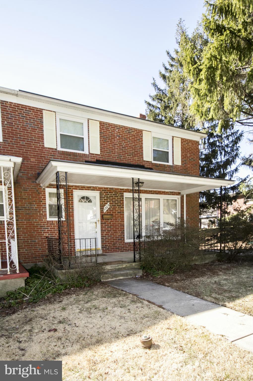 1305 Knightswood Road Baltimore, MD 21239 - Photo 1 of 29 a front view of a house with a yard