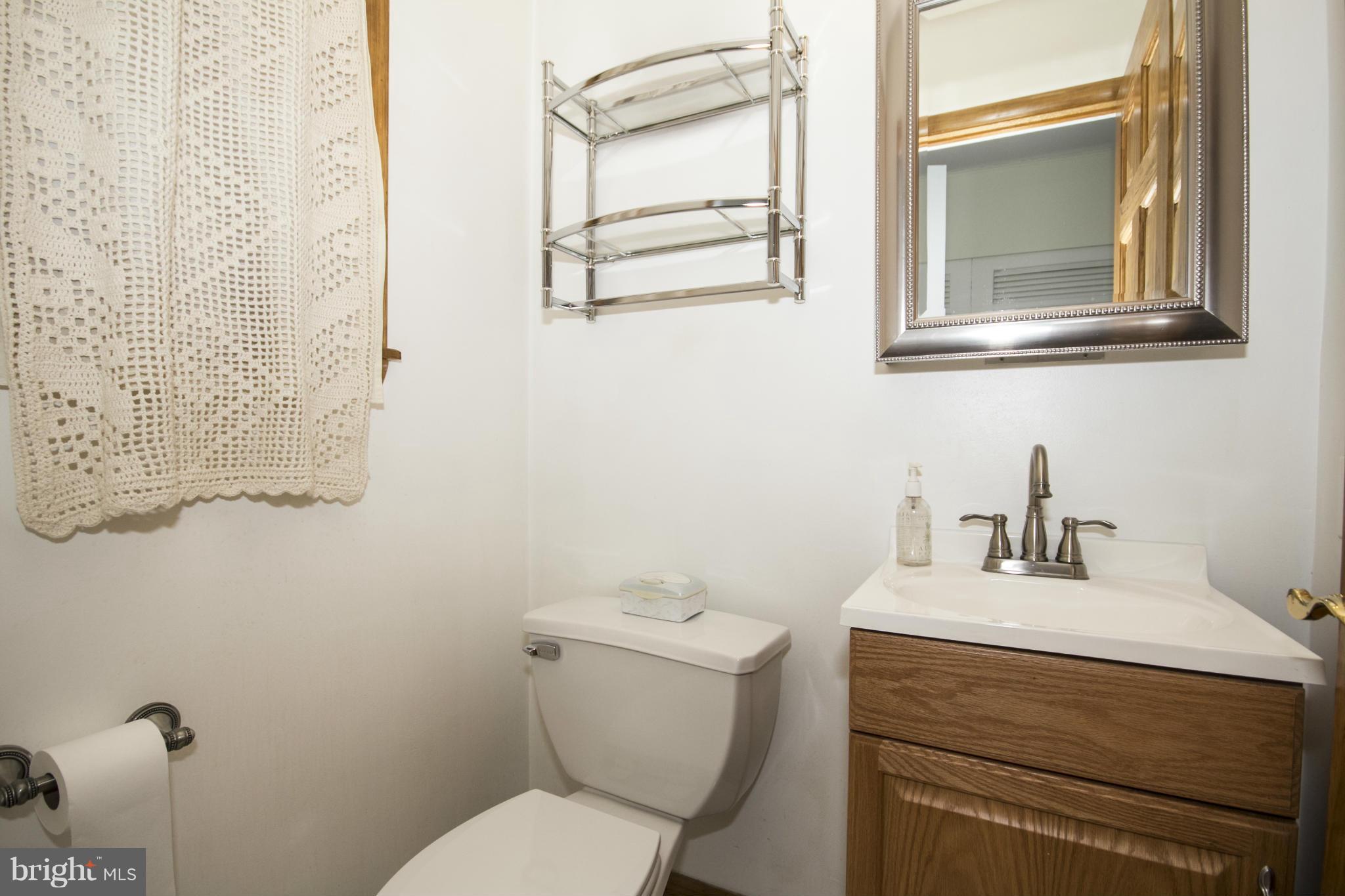 1305 Knightswood Road Baltimore, MD 21239 - Photo 14 of 29 a bathroom with a toilet sink and mirror