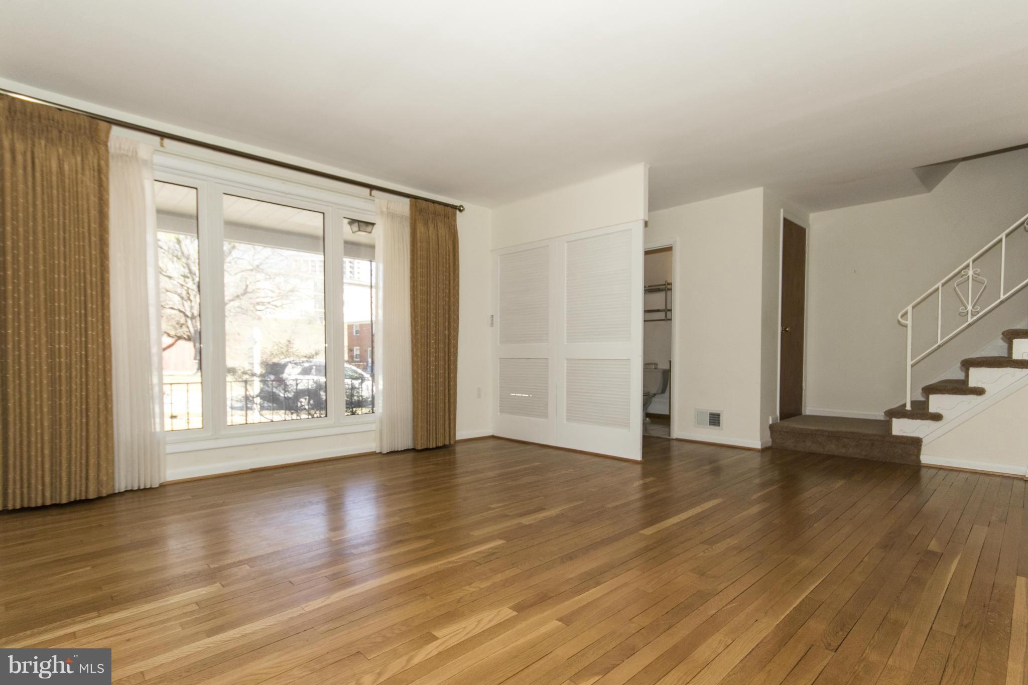 1305 Knightswood Road Baltimore, MD 21239 - Photo 4 of 29 a view of an empty room with wooden floor and a window
