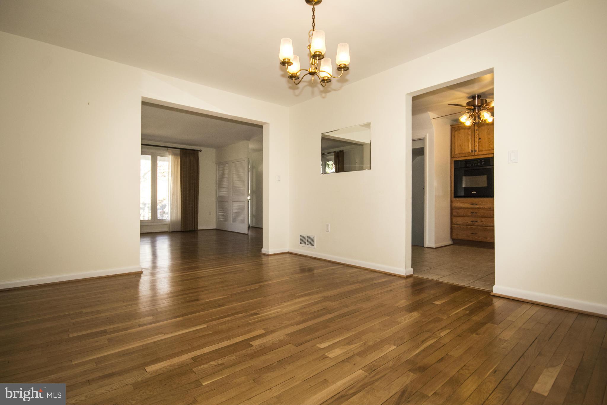 1305 Knightswood Road Baltimore, MD 21239 - Photo 7 of 29 wooden floor in an empty room with a window