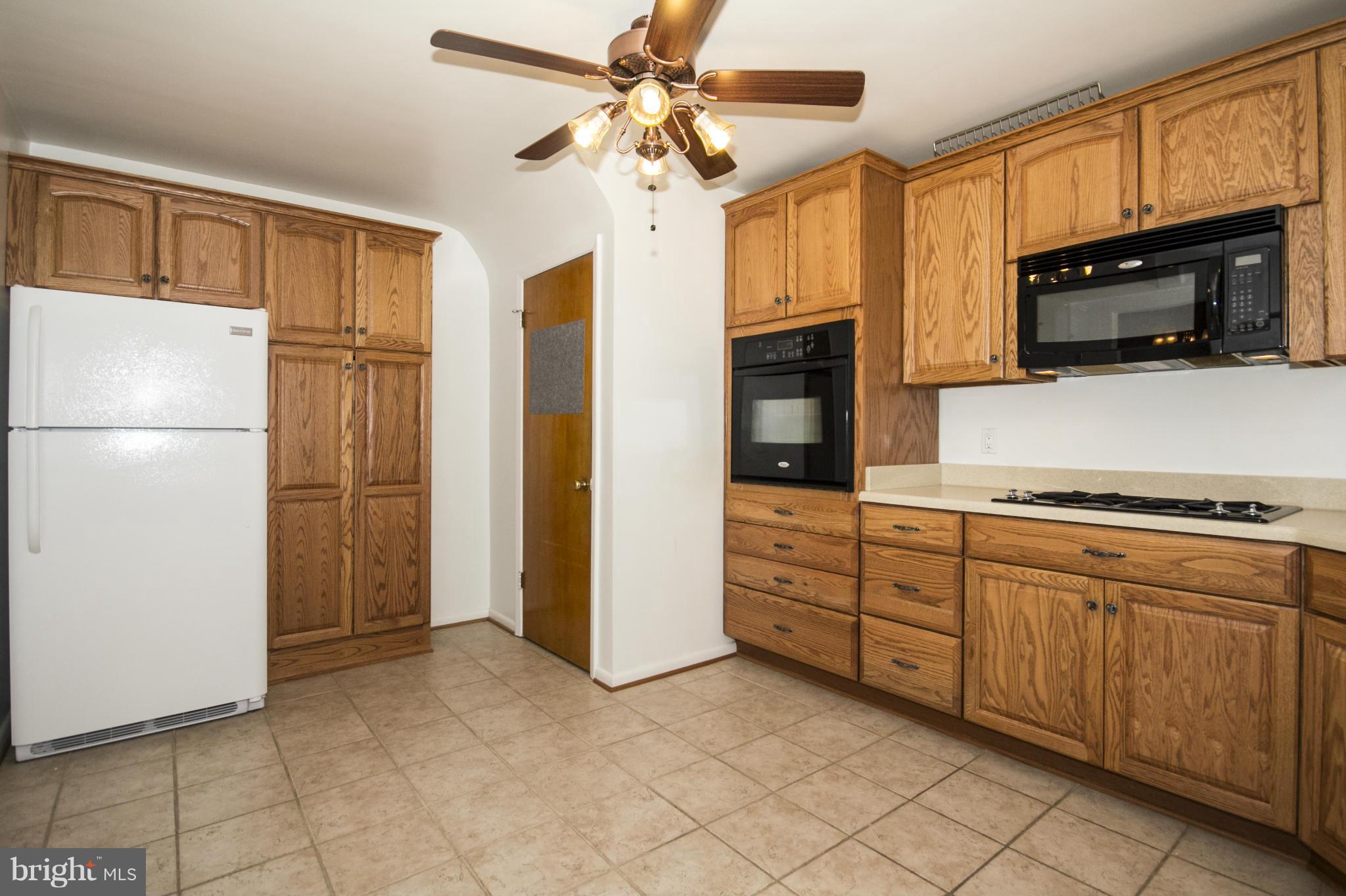 1305 Knightswood Road Baltimore, MD 21239 - Photo 9 of 29 a kitchen with stainless steel appliances granite countertop a refrigerator and a stove top oven